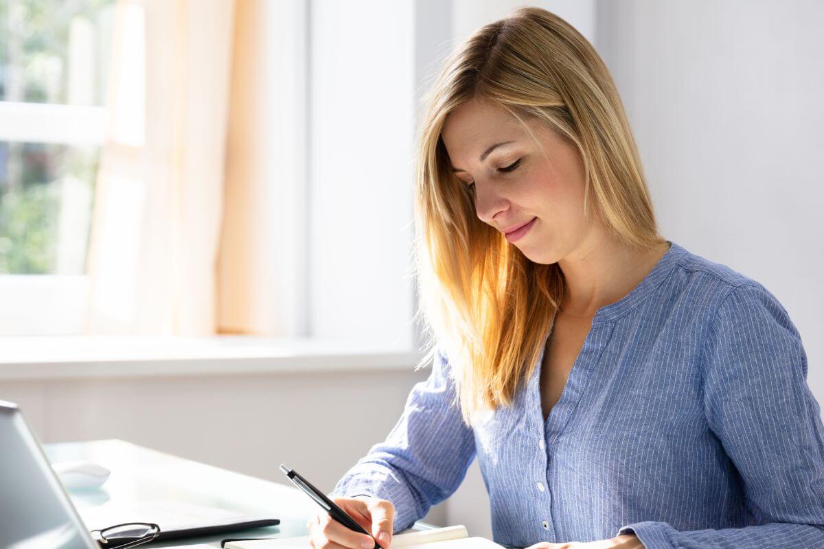 A picture of a woman writing something.
