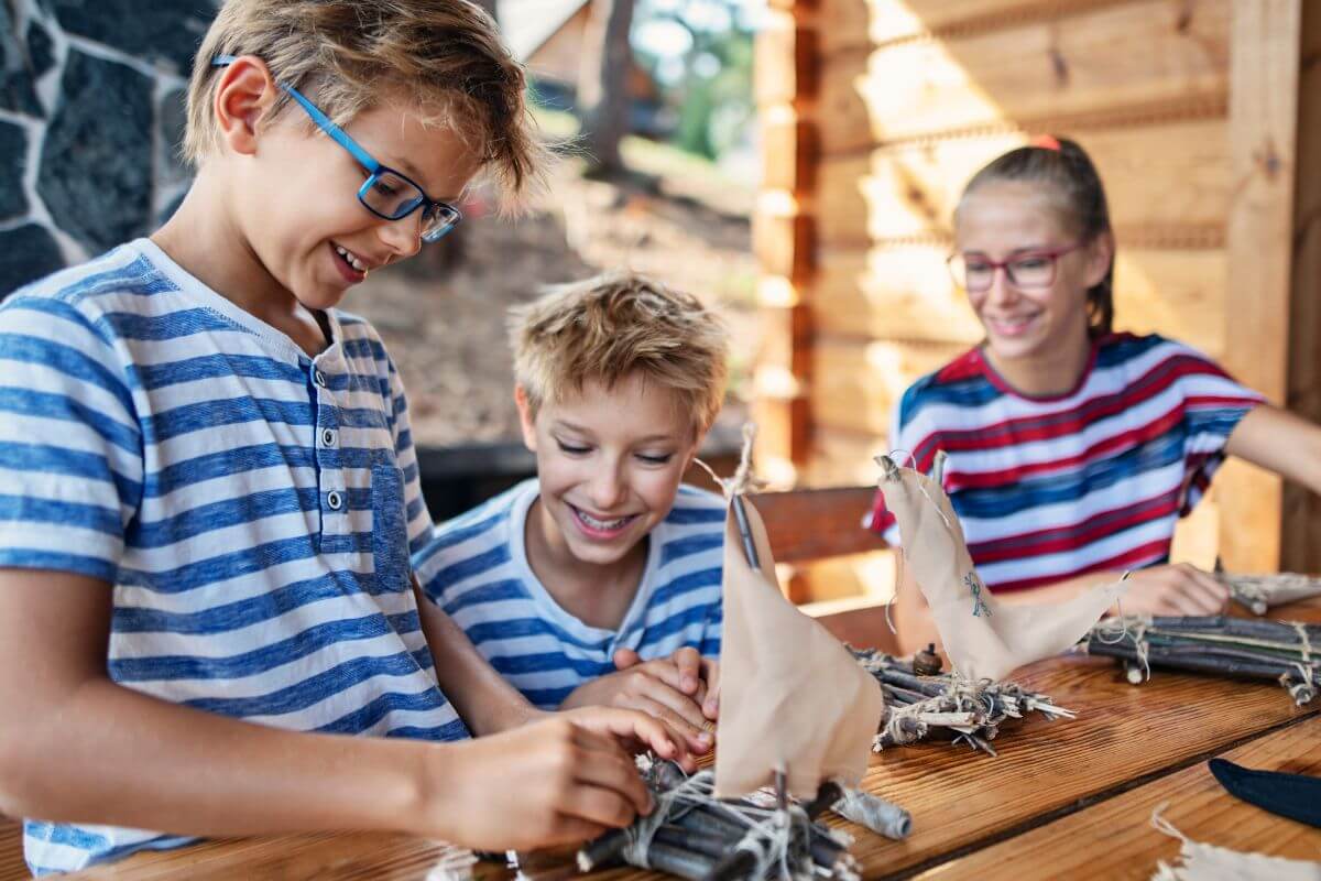 A picture of siblings crafting something.