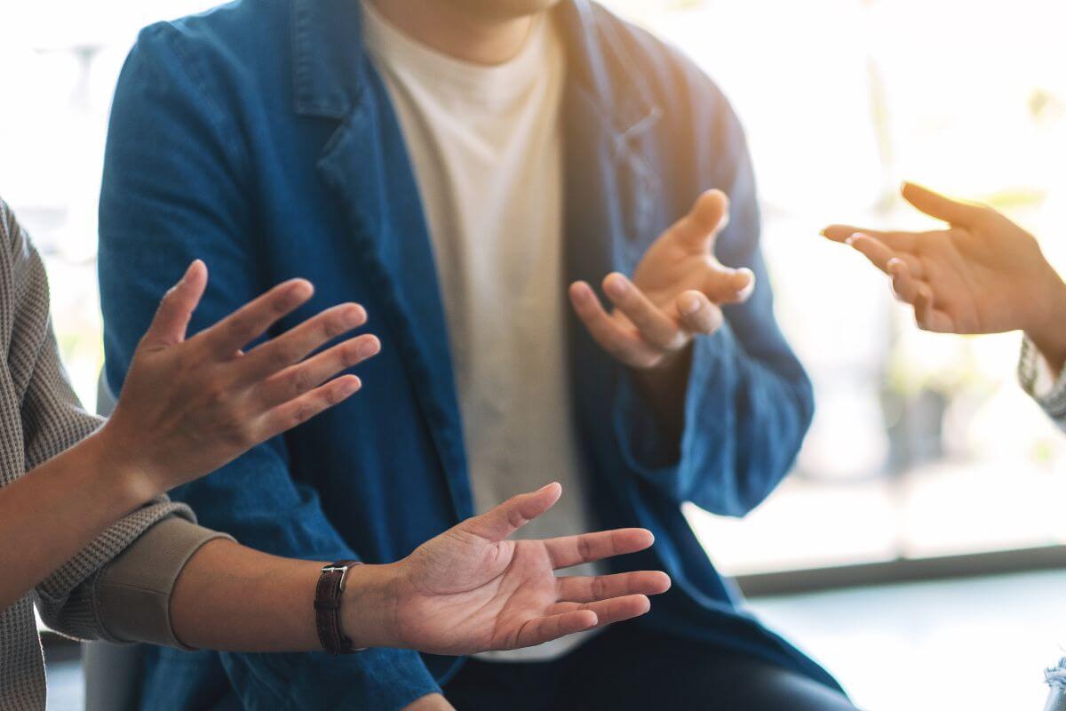 A picture shows a group of people talking.