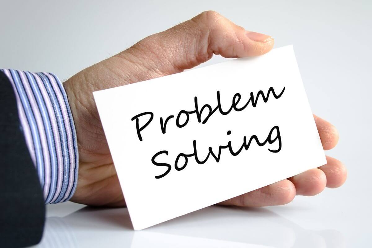 An image shows a man's holding a paper with wording.