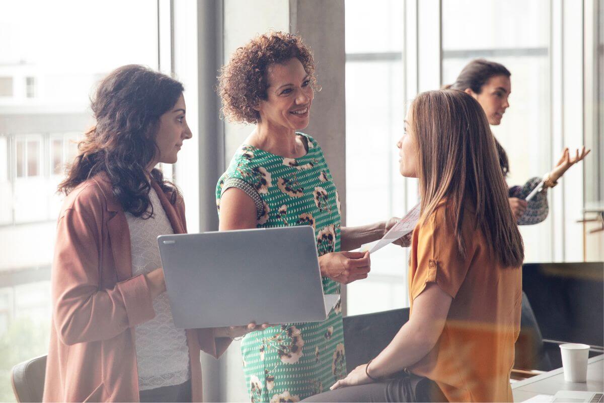 An image shows a group of women talking.