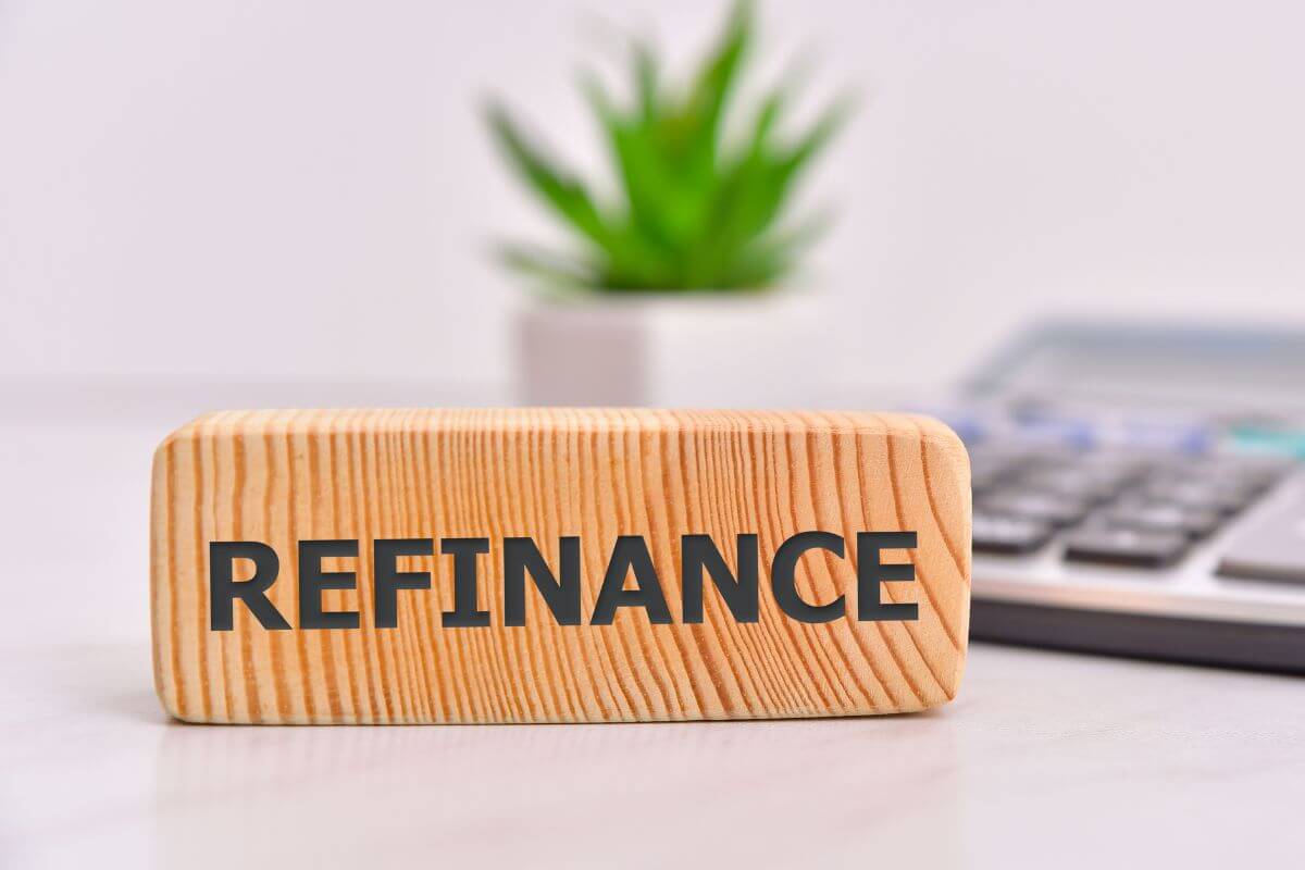 A picture shows refinance wording on a wooden.