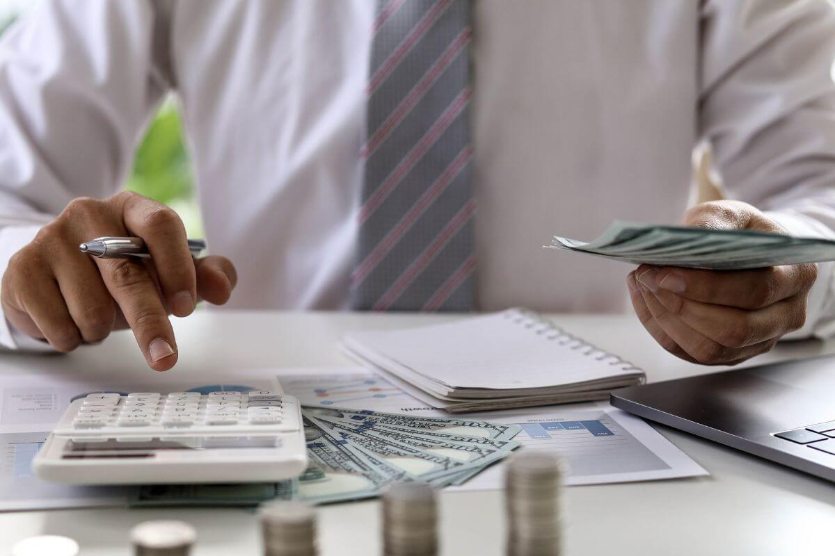 A picture shows a man calculating money.