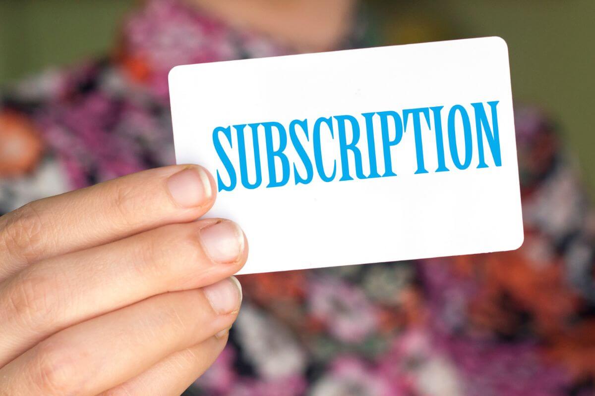 An image of a woman's hand holding a subscription card.