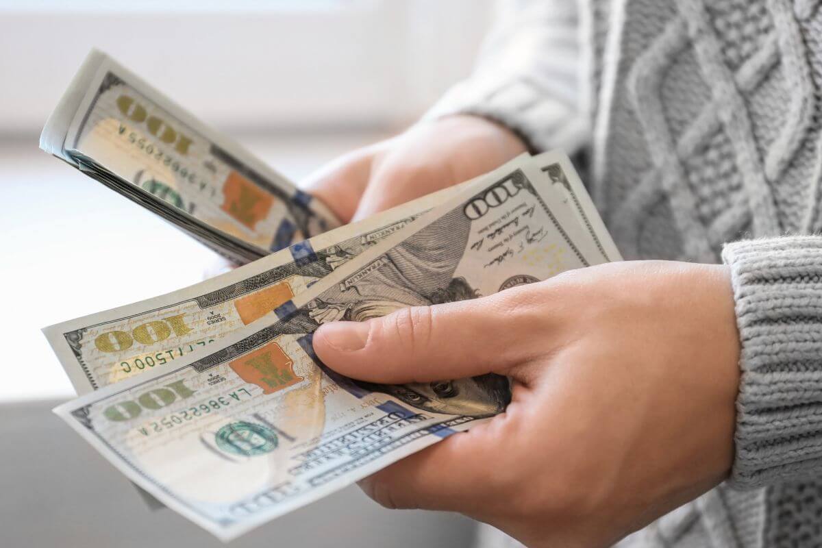 A picture of a man's hand counting money.