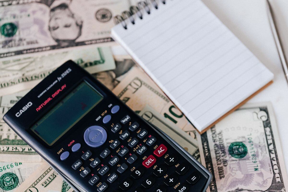 A picture of a calculator and a notepad.