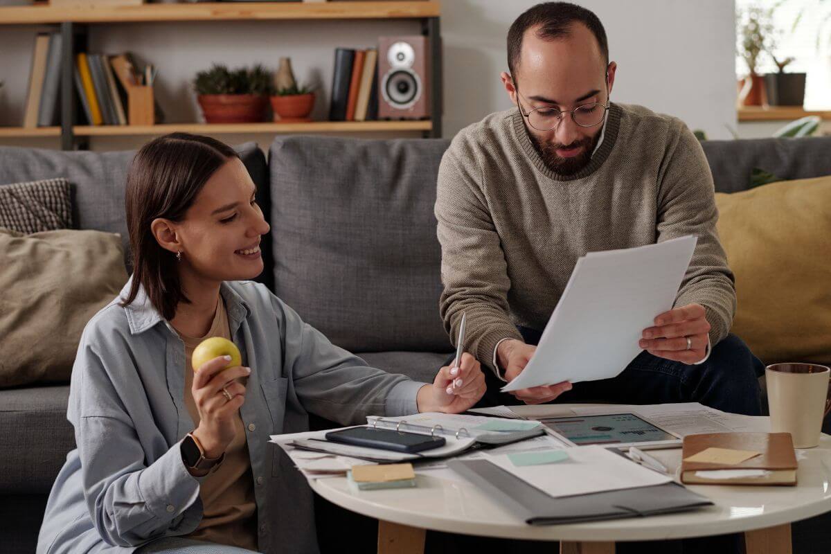 A picture of a man and a woman reviewing their papers.