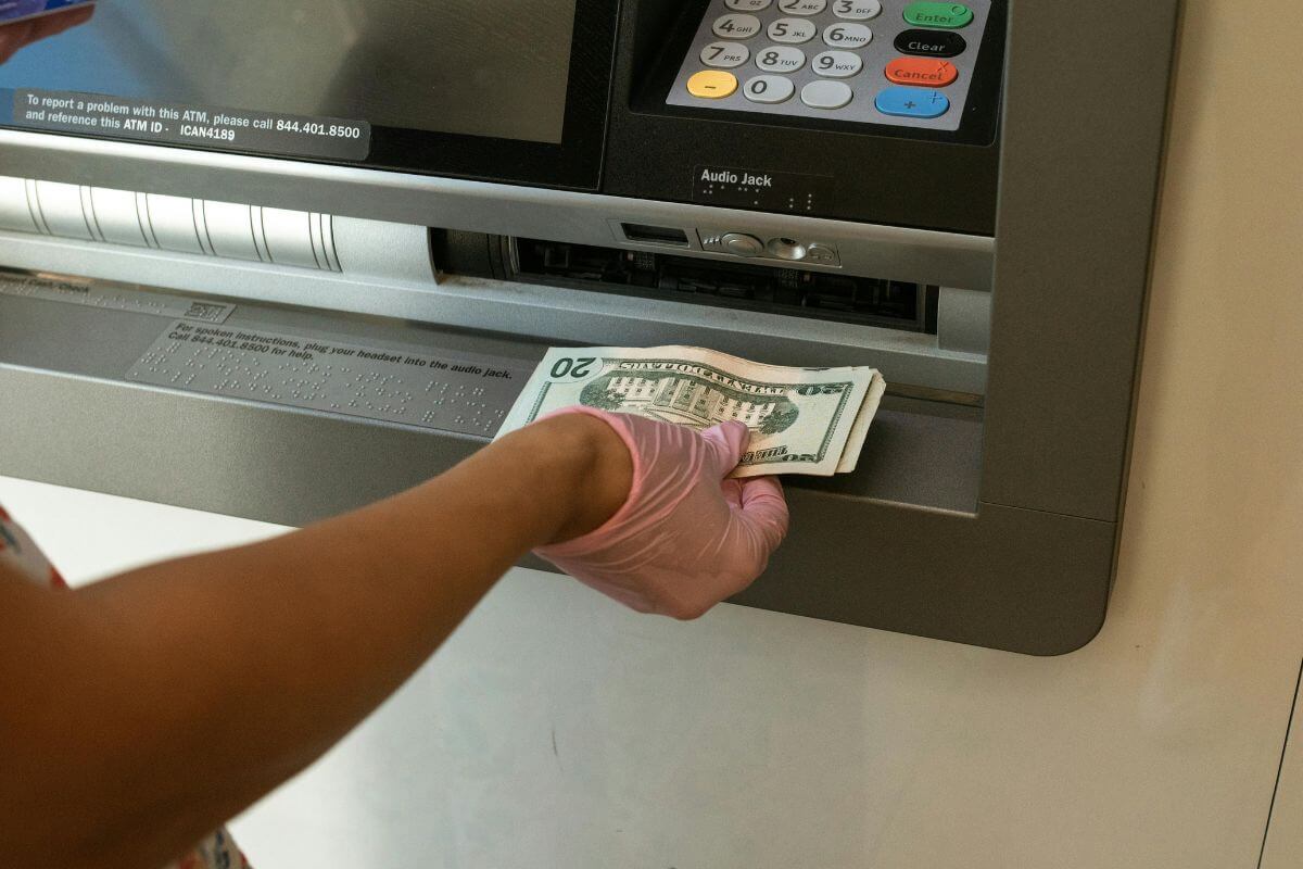 A picture of someone depositing some money.