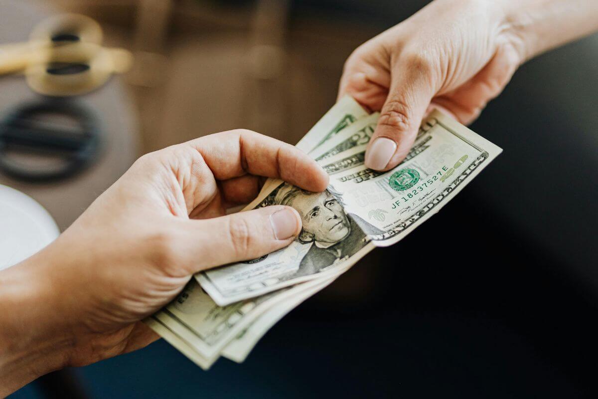A picture of someone giving money.