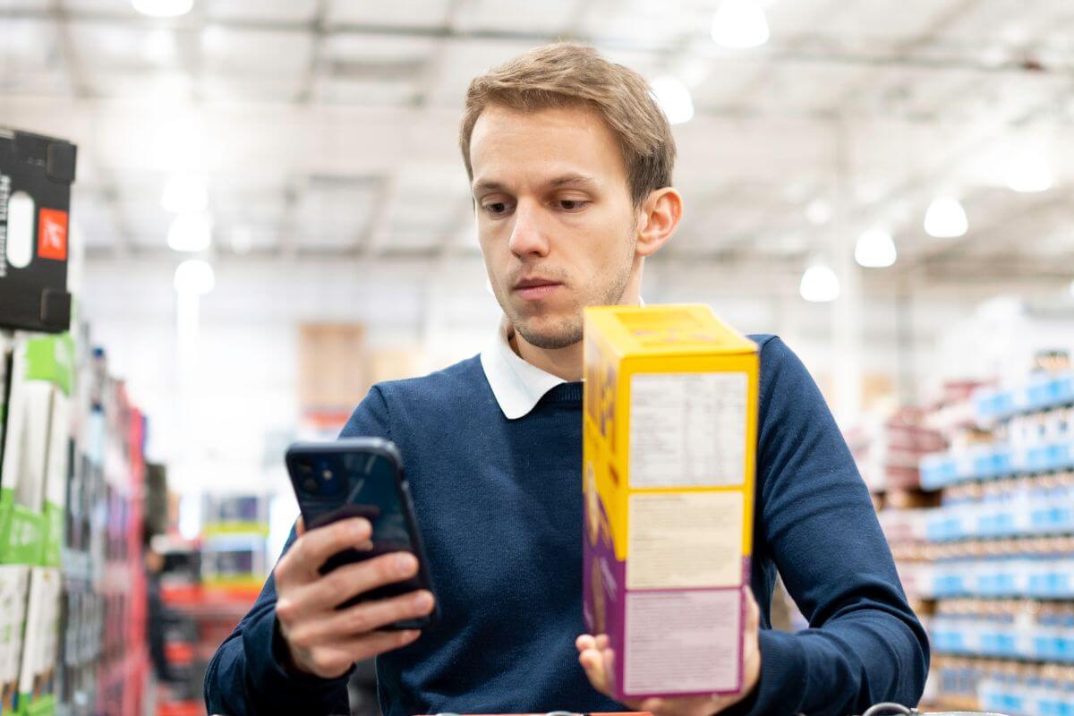 A picture of someone comparing prices.