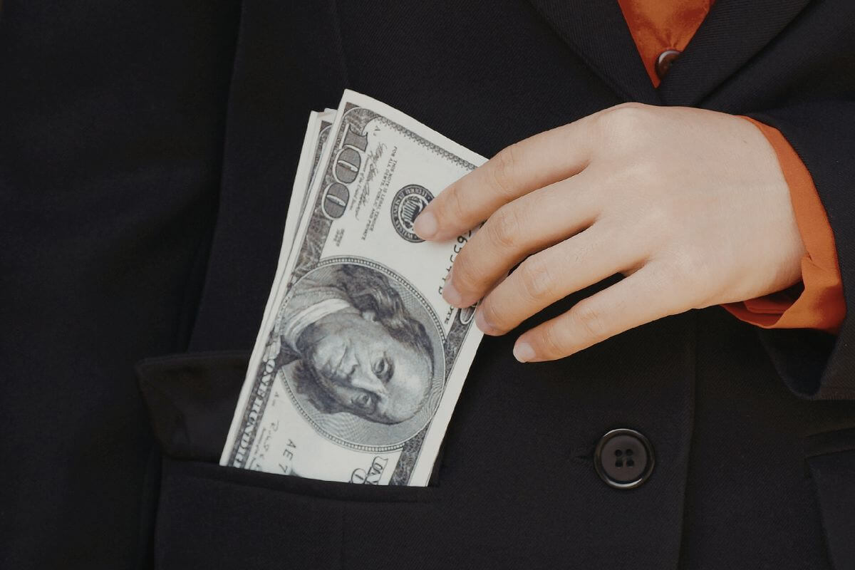 A picture of money in a pocket.