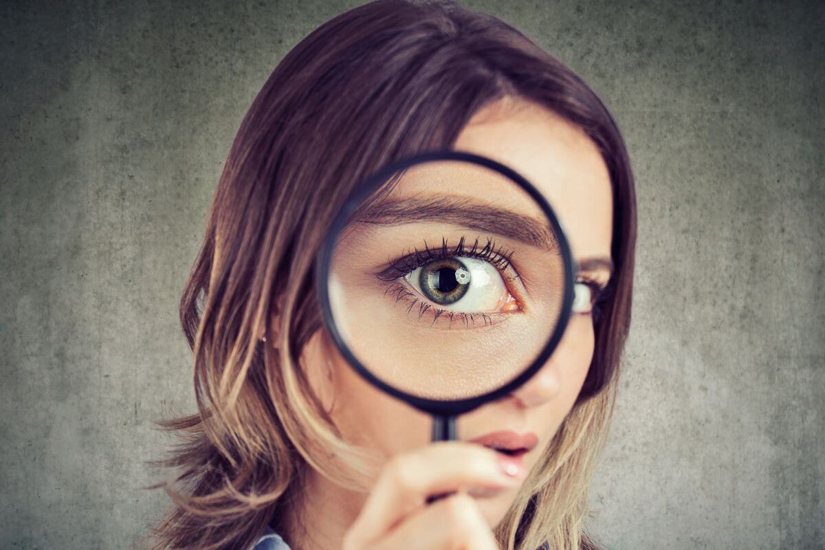 A picture of someone looking through a magnifying glass.