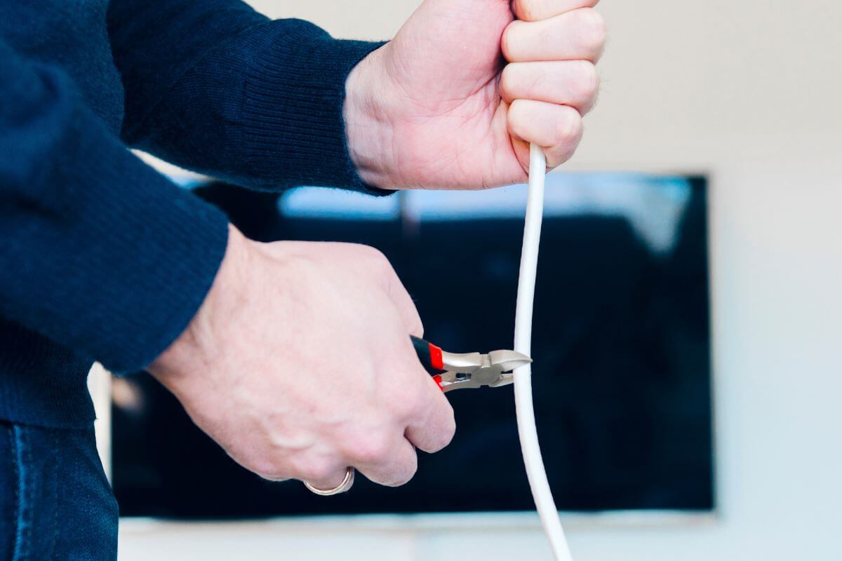 A picture of someone cutting their cable.