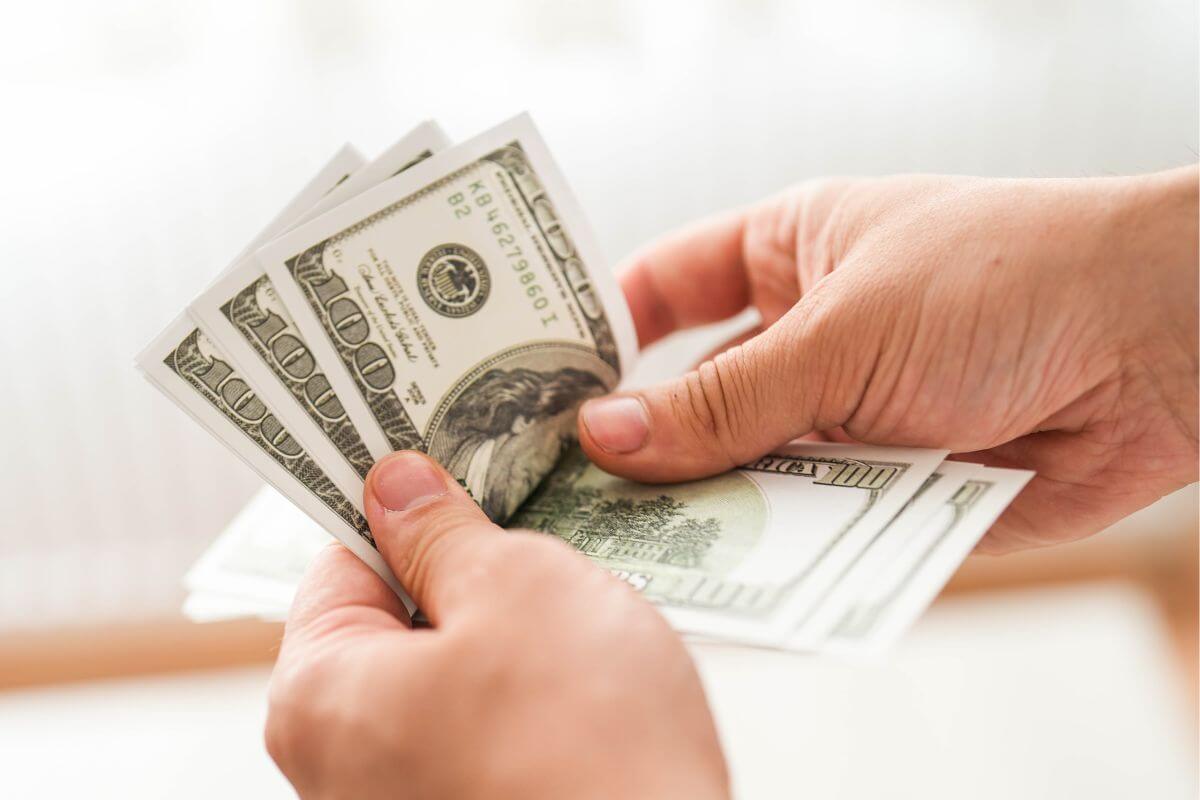 A picture shows a man's hand counting money.