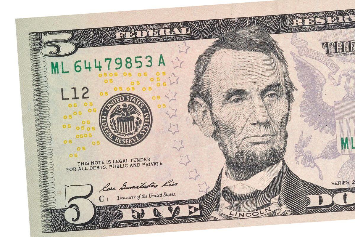 A picture shows a $5 bill.