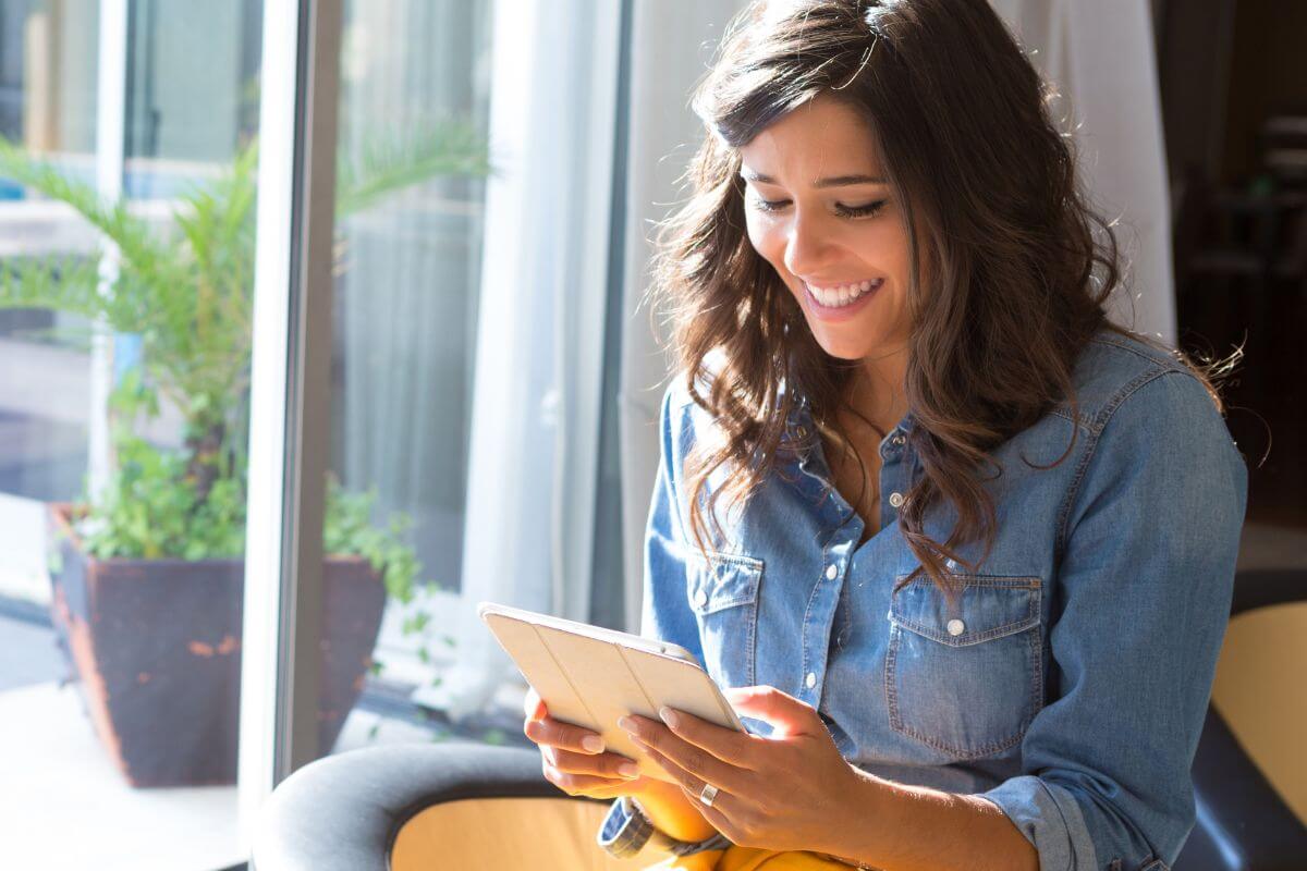 A picture shows a woman using a tablet device.