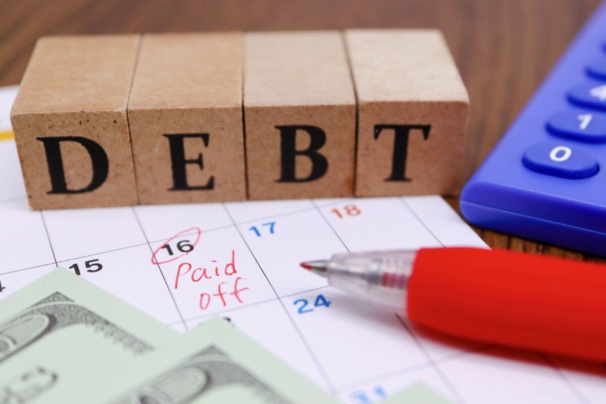 A picture shows debt wording and a calendar with note.