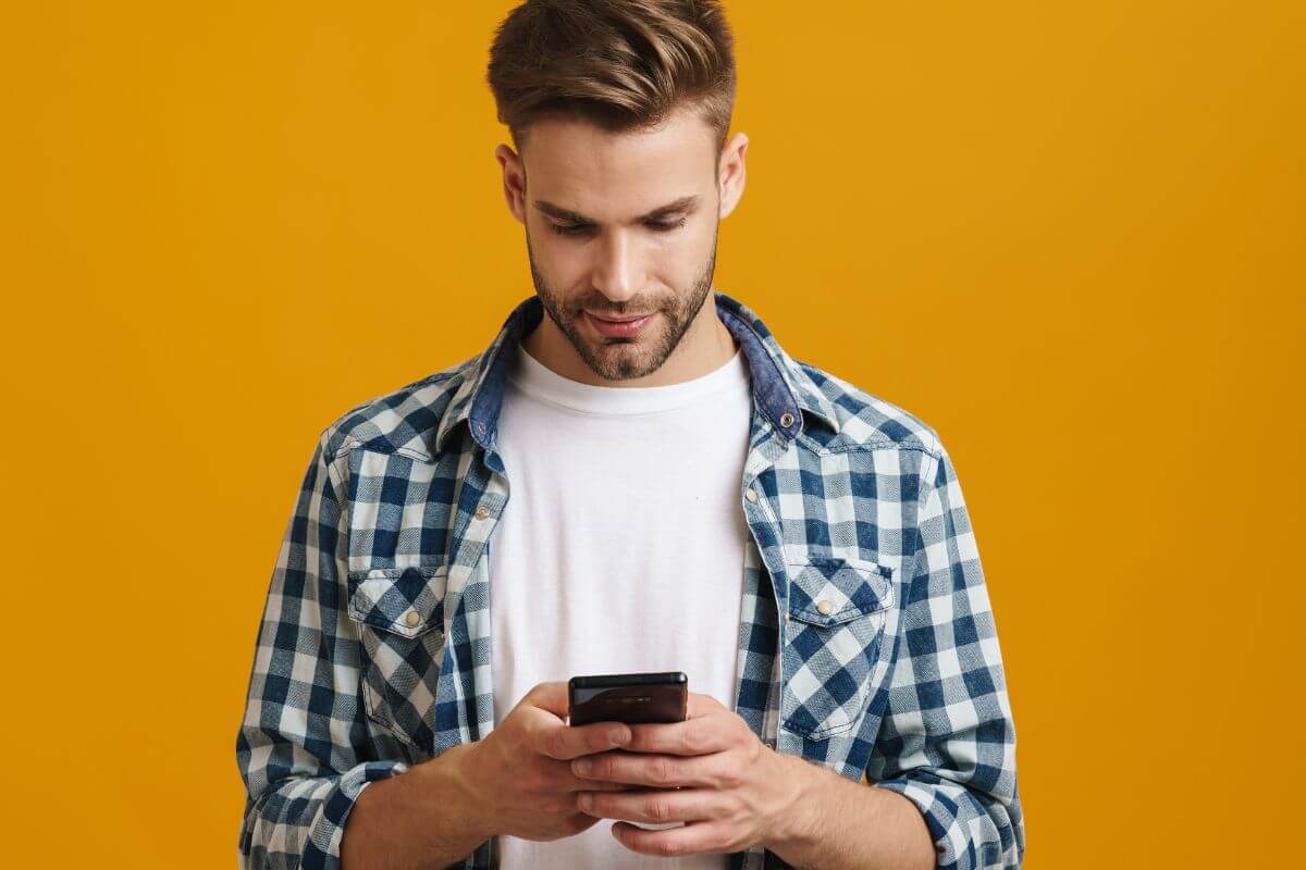 A picture of a man using a phone.