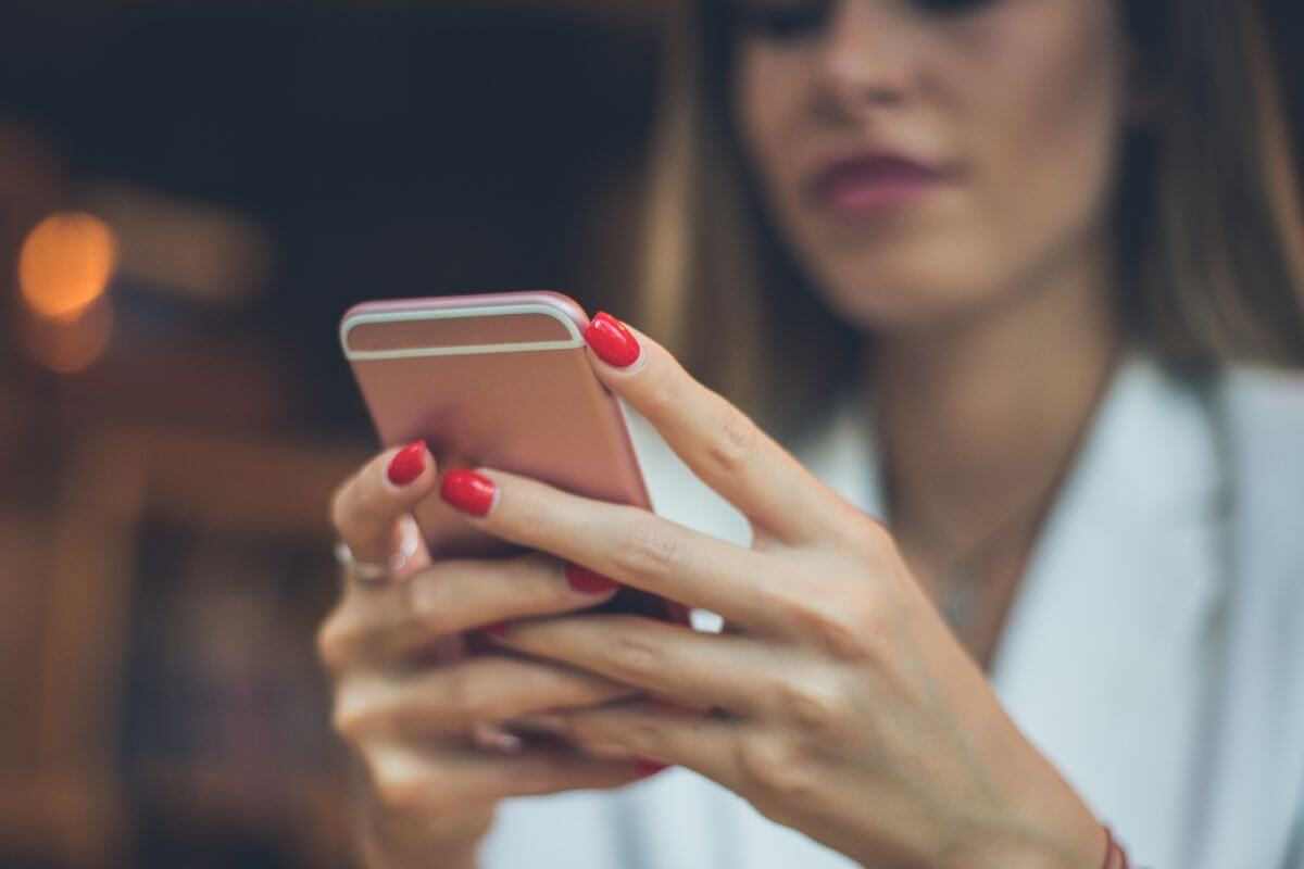 A picture shows a woman using a phone.