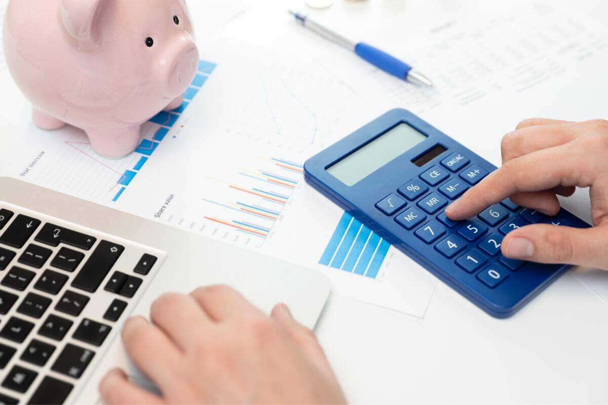 A picture of a man's hand making a budget.