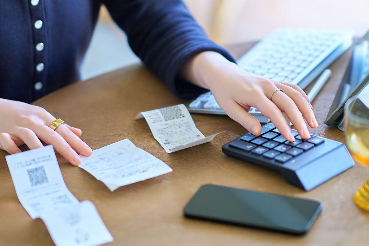 A picture shows a woman calculating the receipts.
