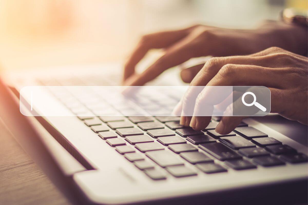 An image of a woman's hand searching something online.