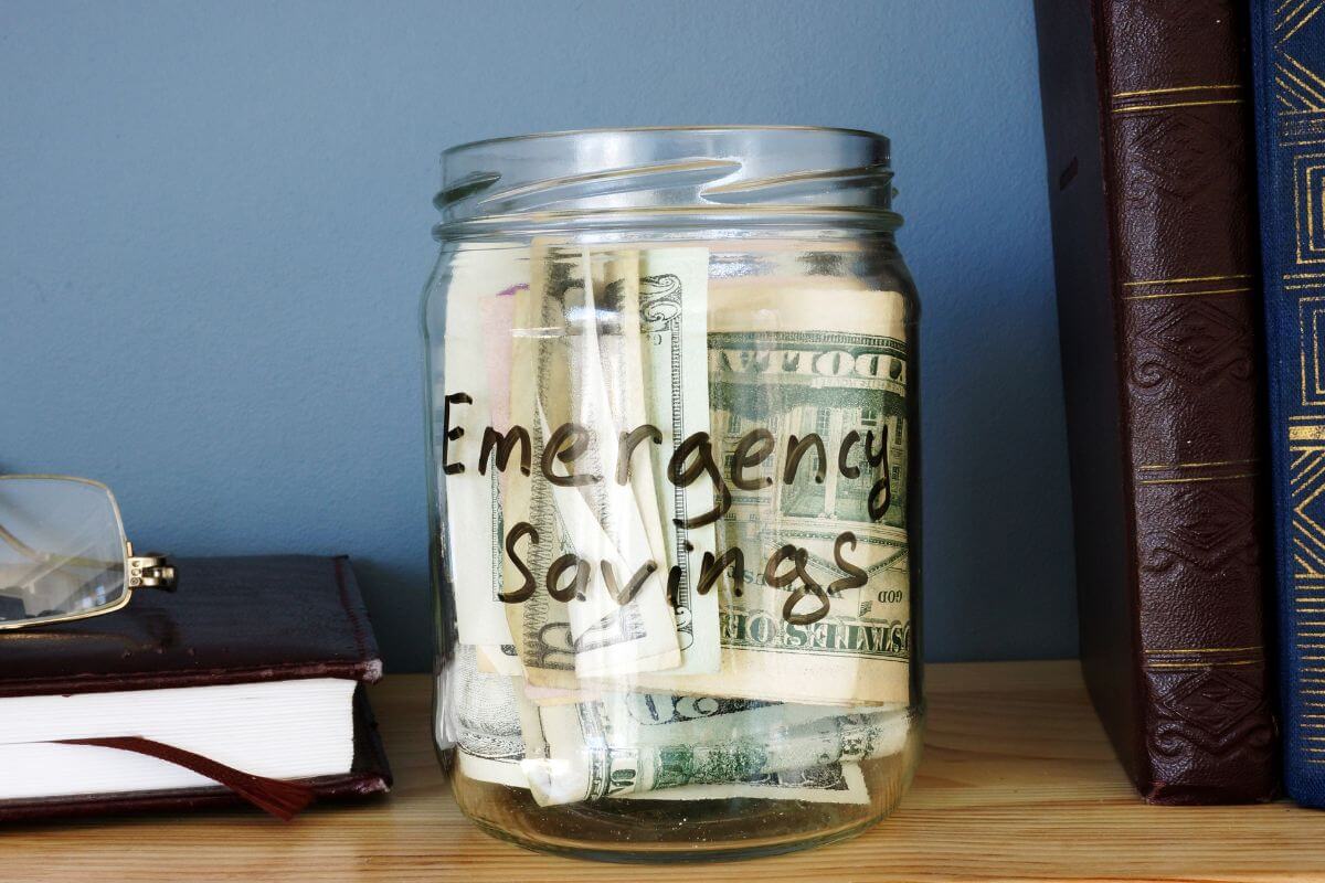 A picture shows a jar with emergency savings.