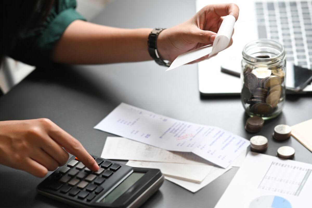 An image of a woman calculating receipts.