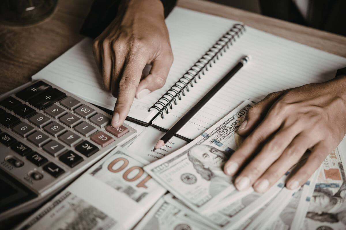An image of a man's hand calculating money.