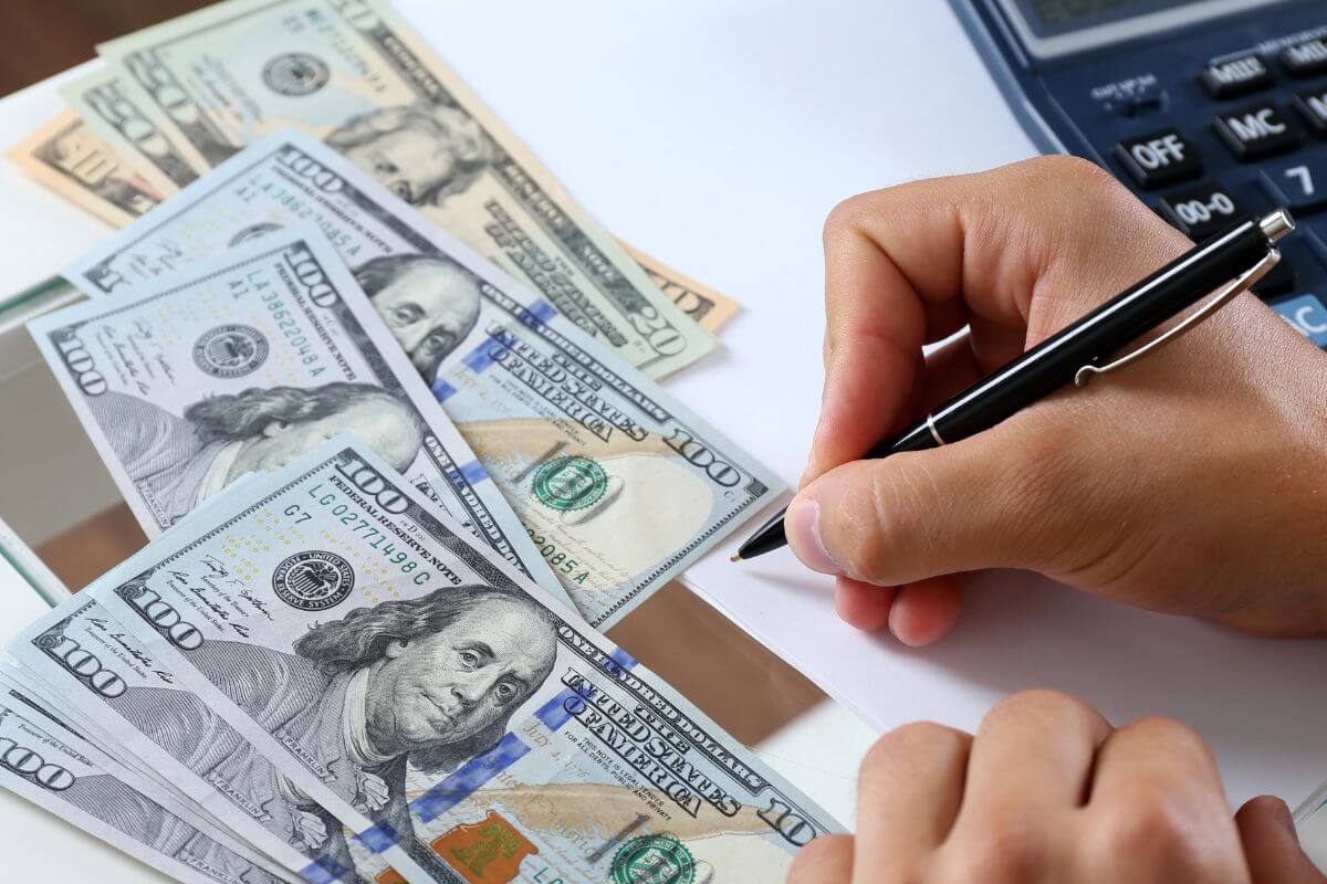 A picture shows a man tracking his spending.