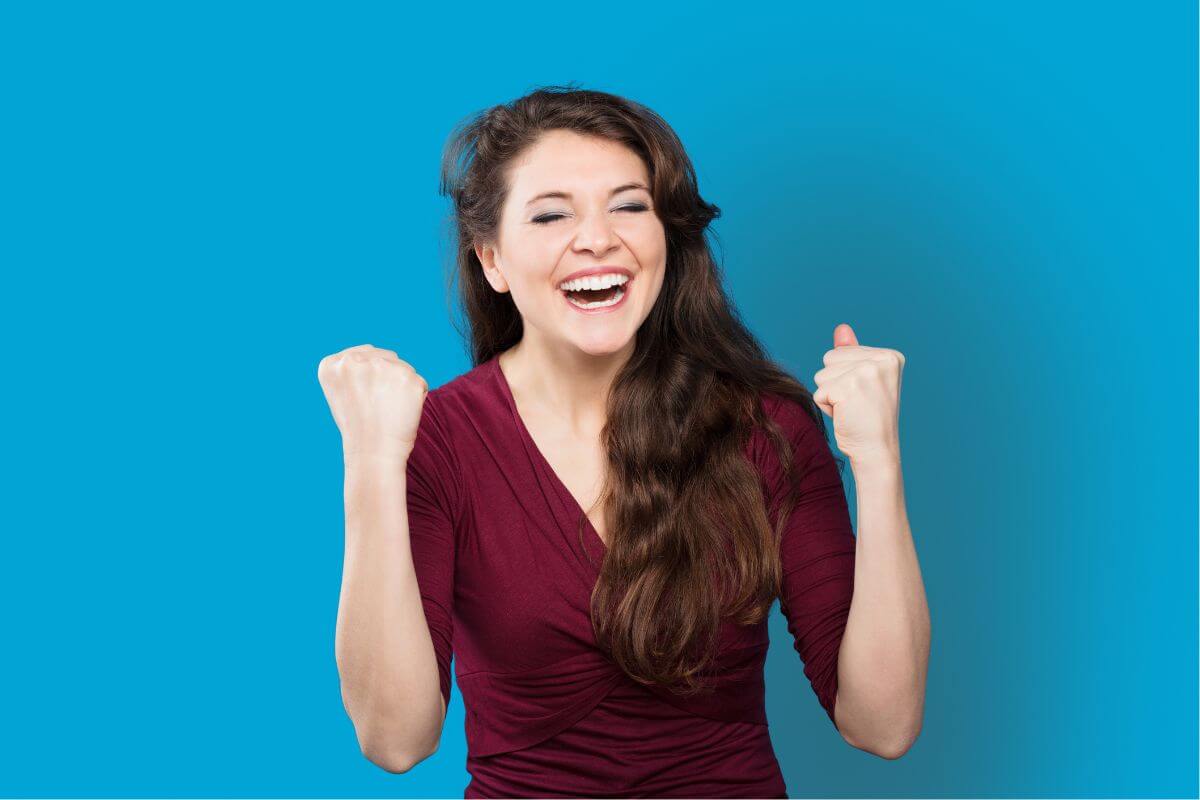 A picture of a woman cheering in happiness.