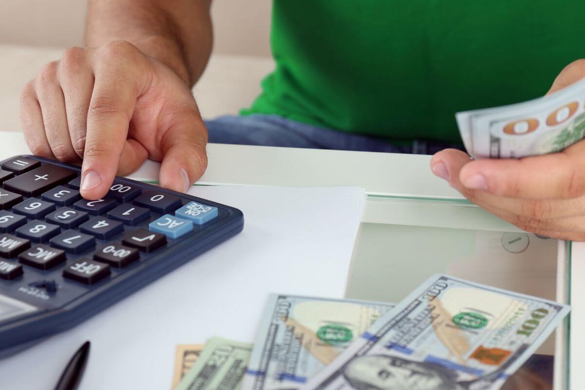 An image of a man calculating money.