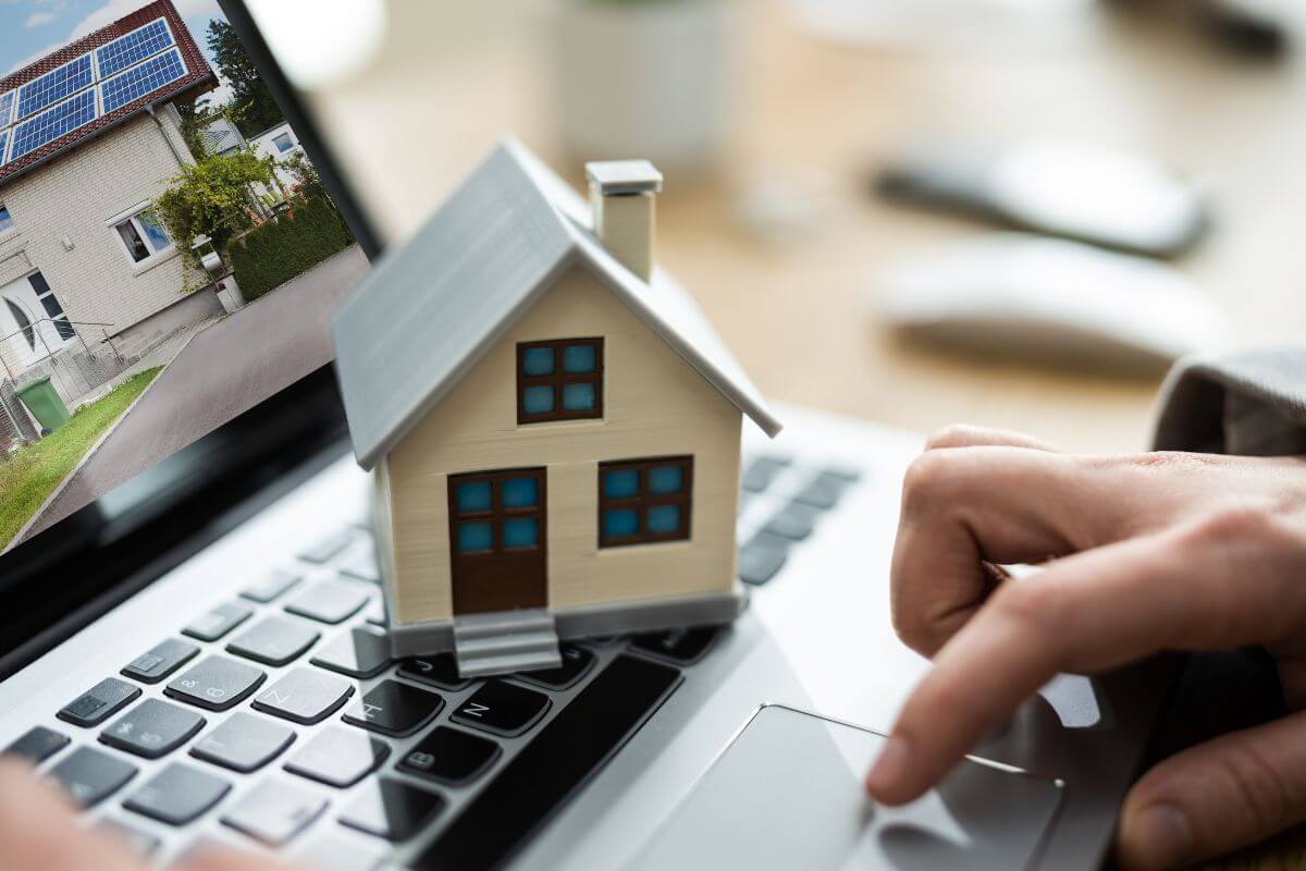 A picture of a woman's hand searching real estate online.