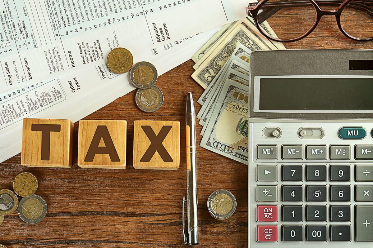 A picture shows tax wording and money on the table.