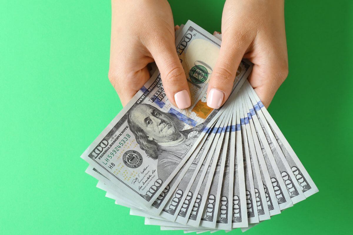 A picture of a woman's hand holding money.