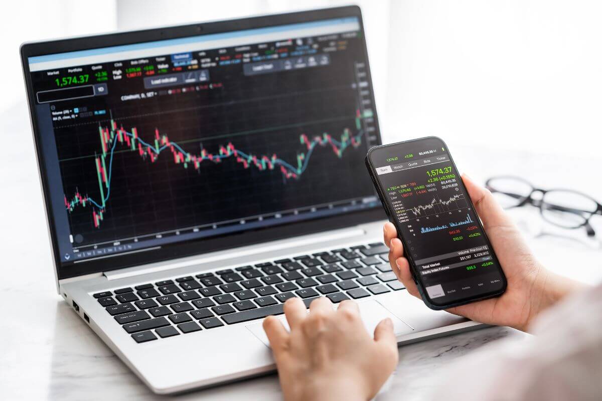 A photo of a man's hand checking stock information online.