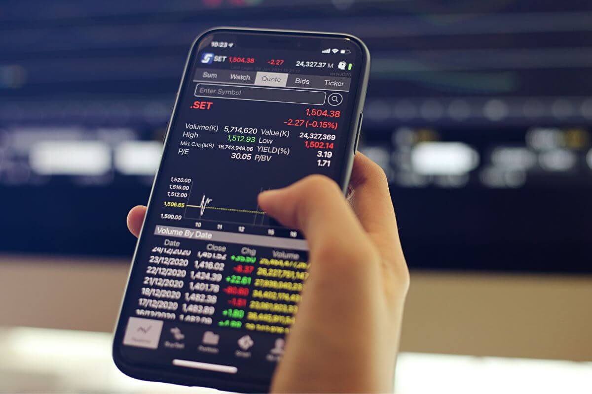 An image shows a man's hand using a phone.