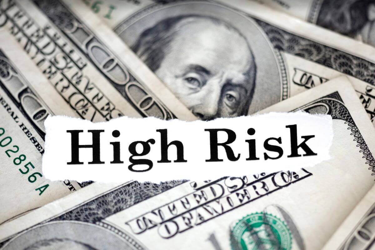 A picture of money and paper with high-risk wording.