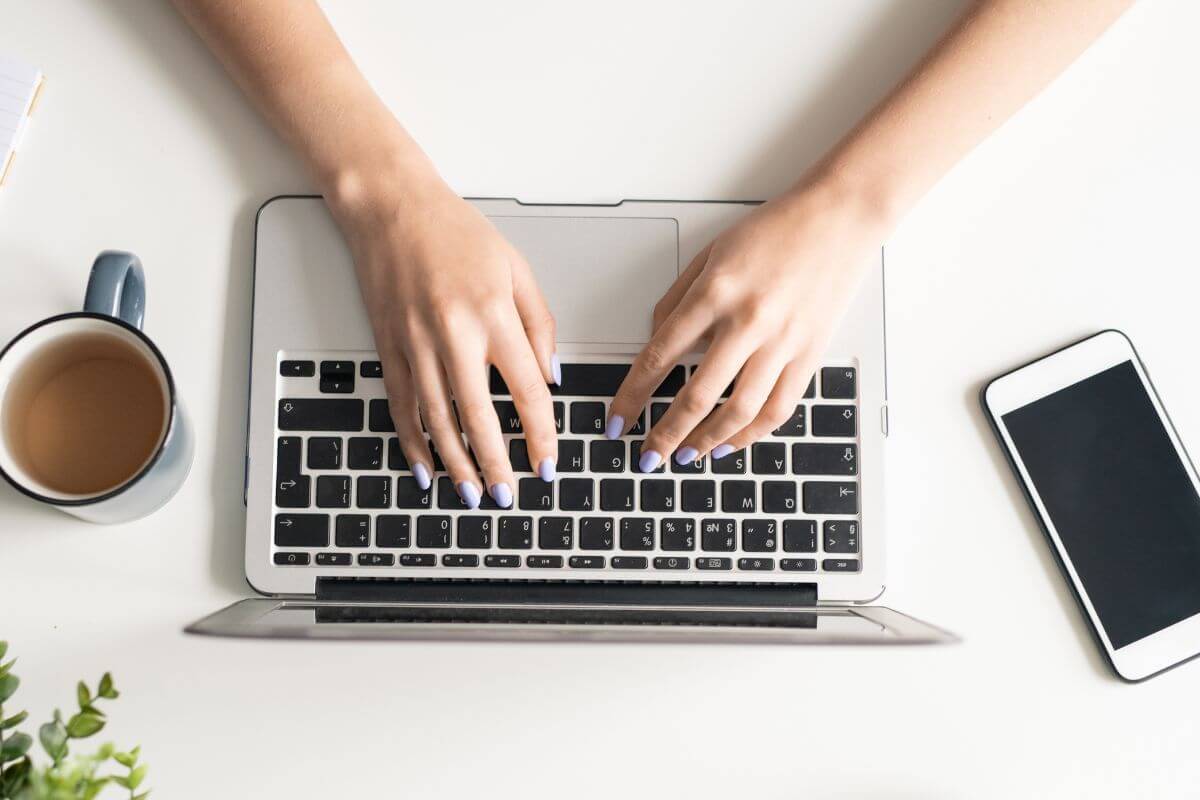 An image shows a woman using a laptop.