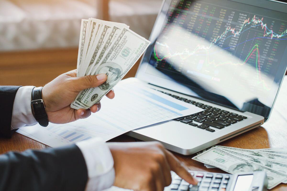 A picture shows a man's hand calculating his money.