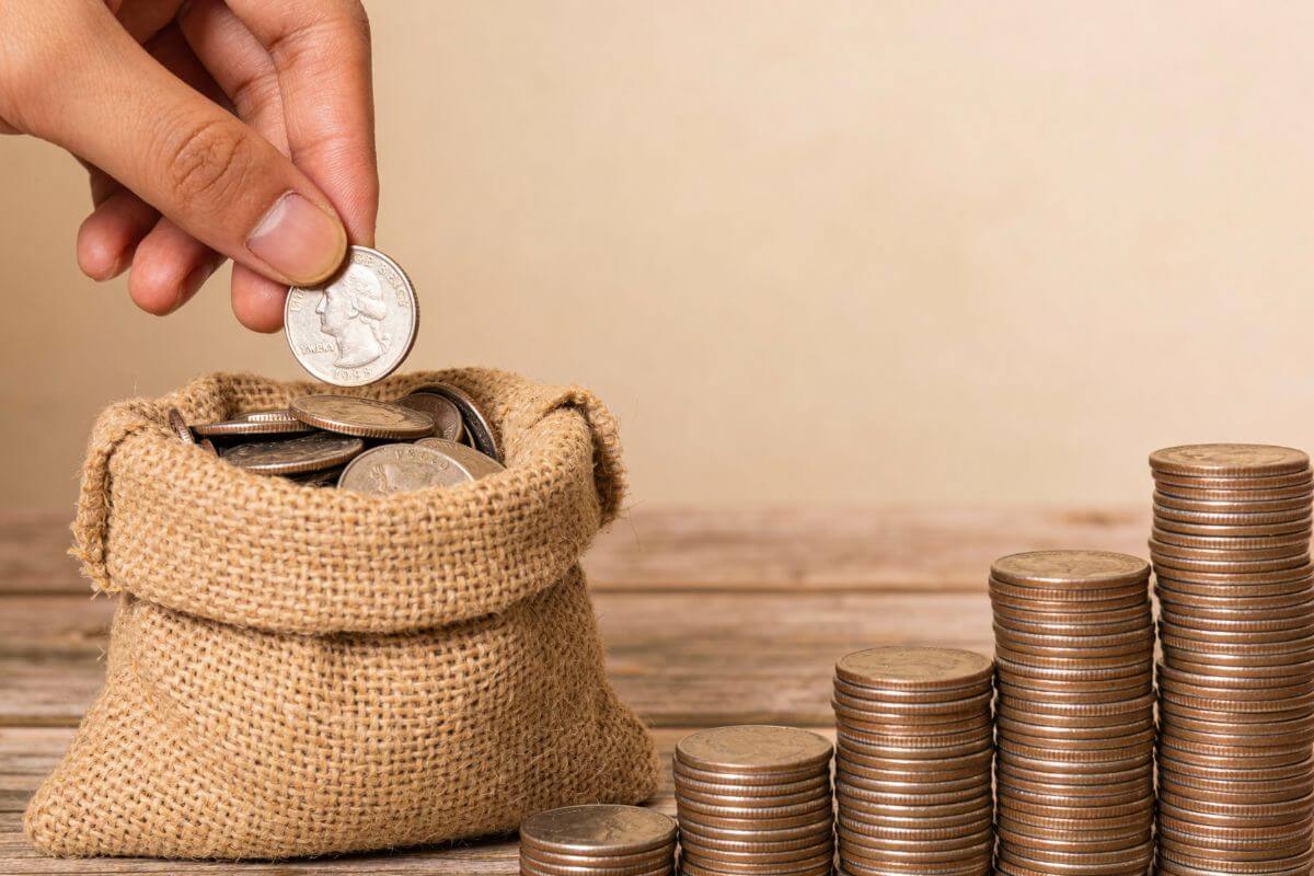 A picture of a woman's hand saving money.