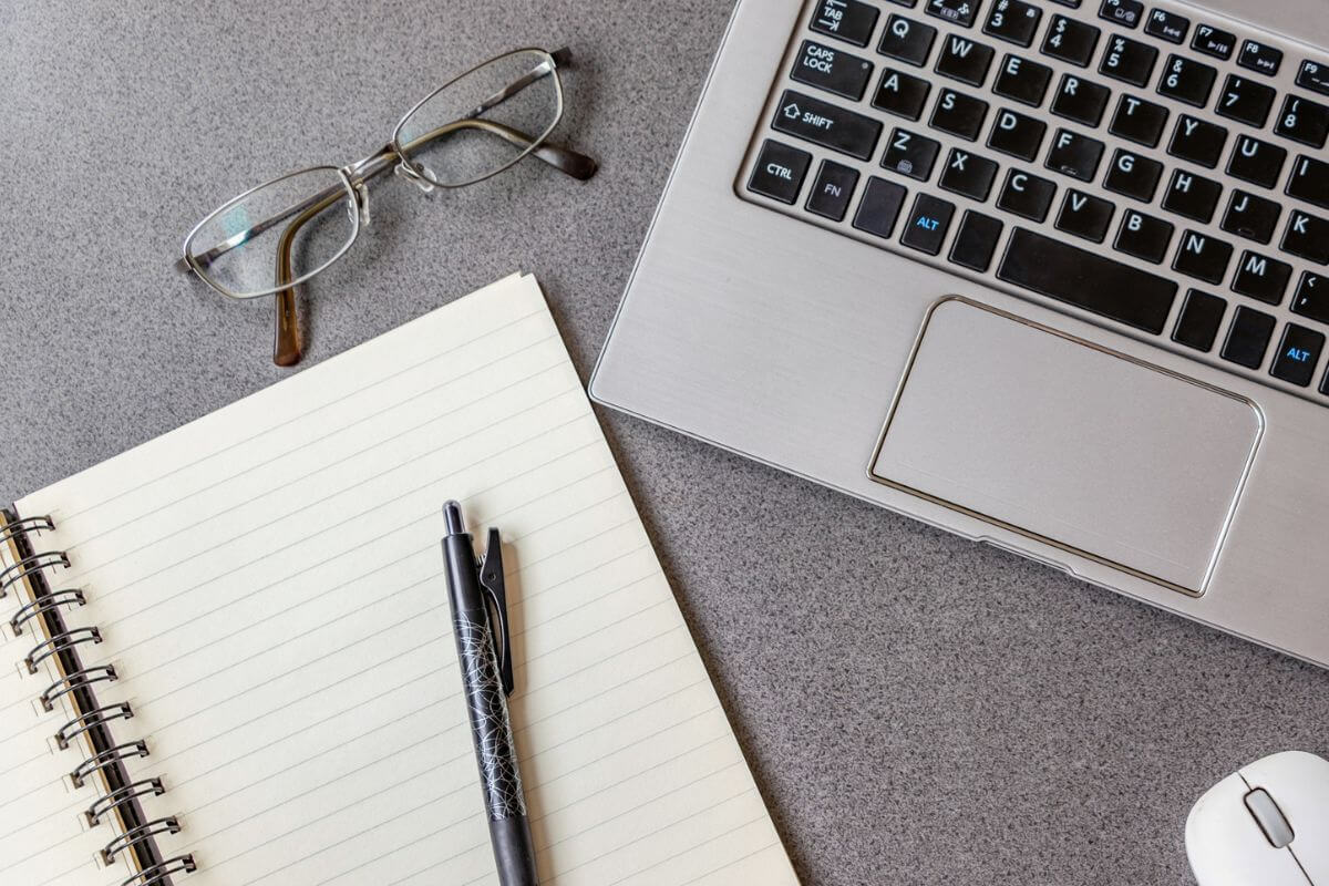 A picture shows a laptop and a notebook.
