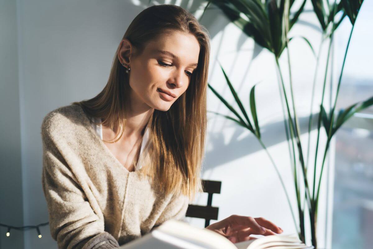 An image shows a woman reading a book.