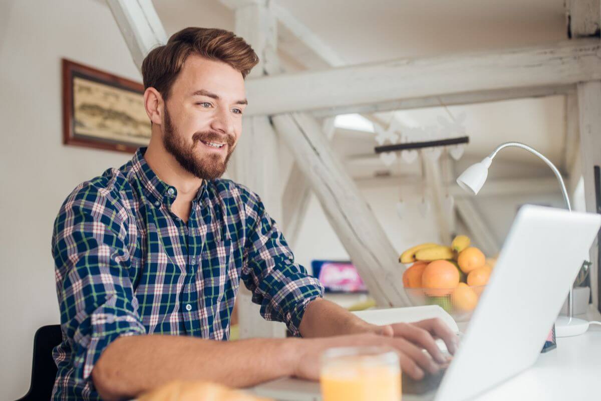 A picture shows a man using a laptop.