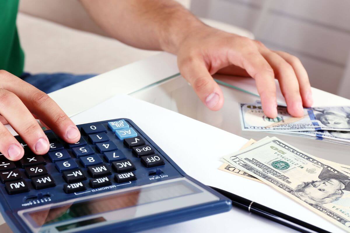 A picture shows a man calculating his money.