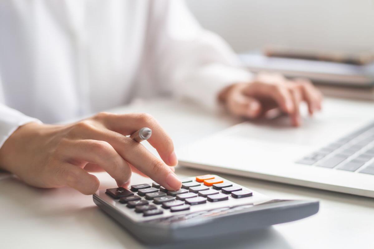 An image shows a woman calculating something.
