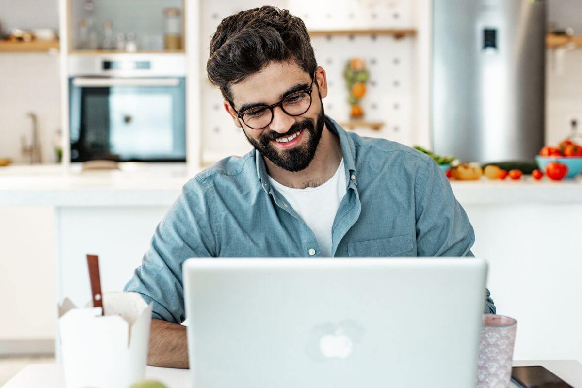 A picture shows a man working on a laptop.