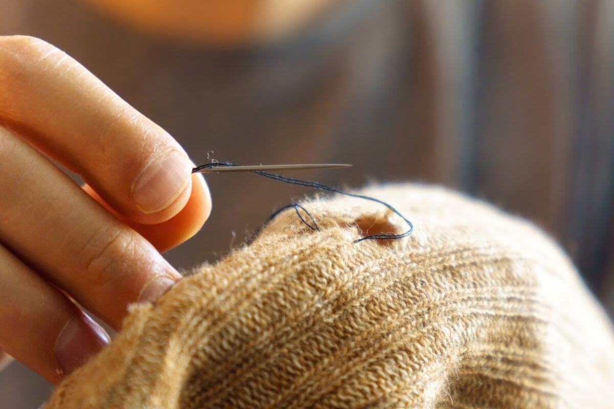 A picture of a woman mending clothes.