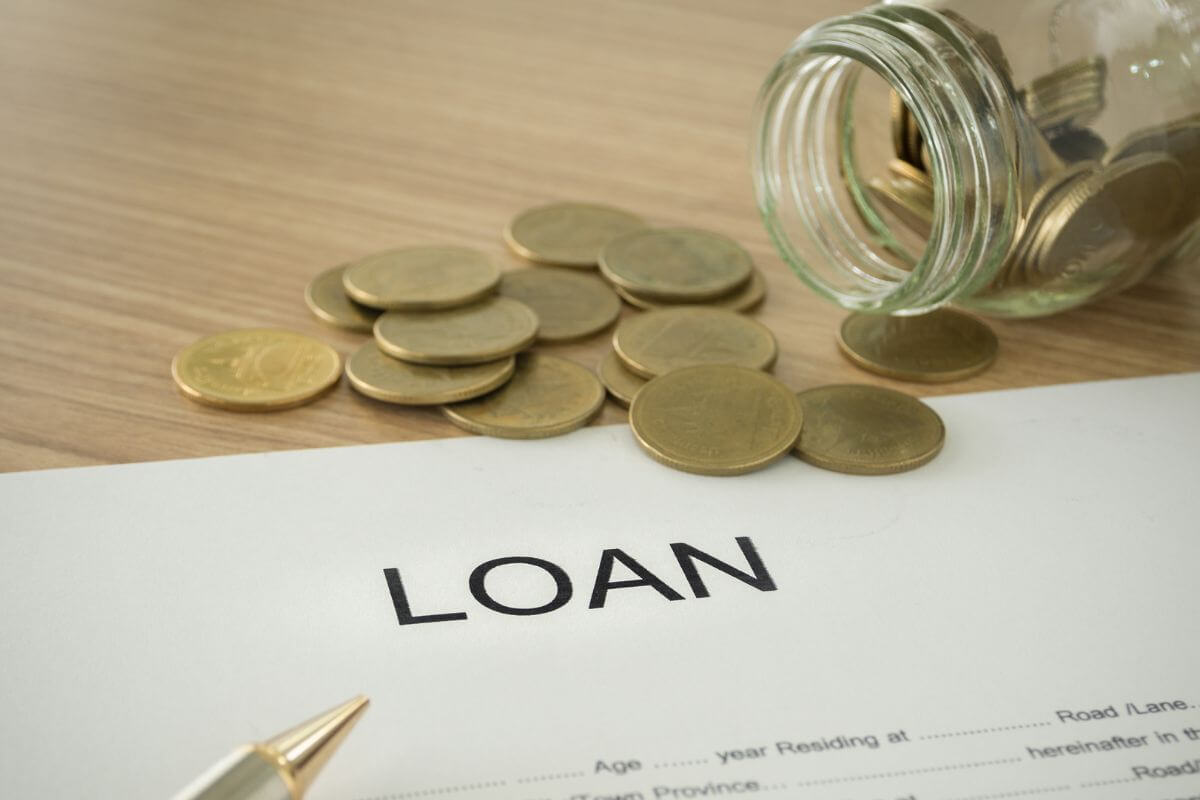 An image of a load document and some coins.