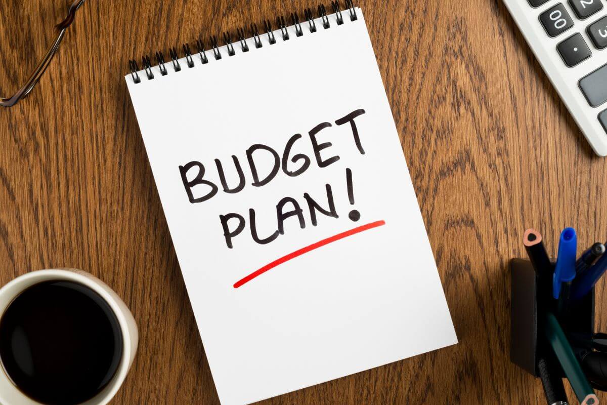 A picture of a notebook with a budget plan written on it.